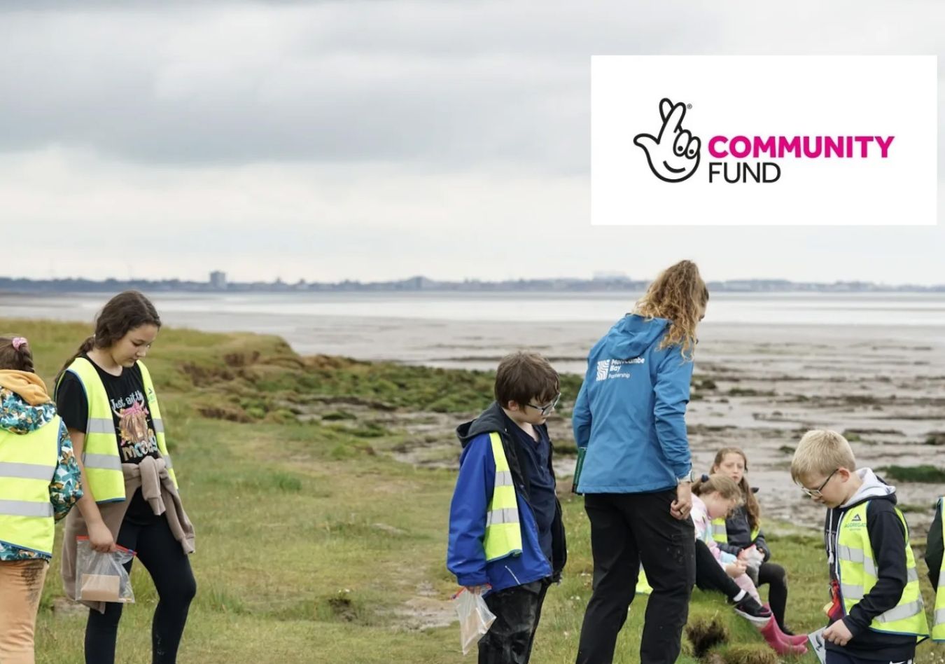 Children and an adult by the shore
