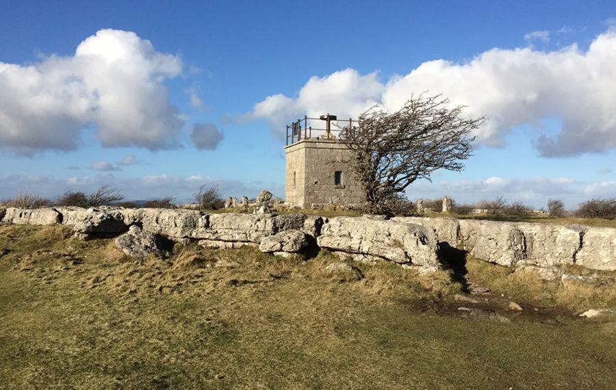 A tower next to a rock face
