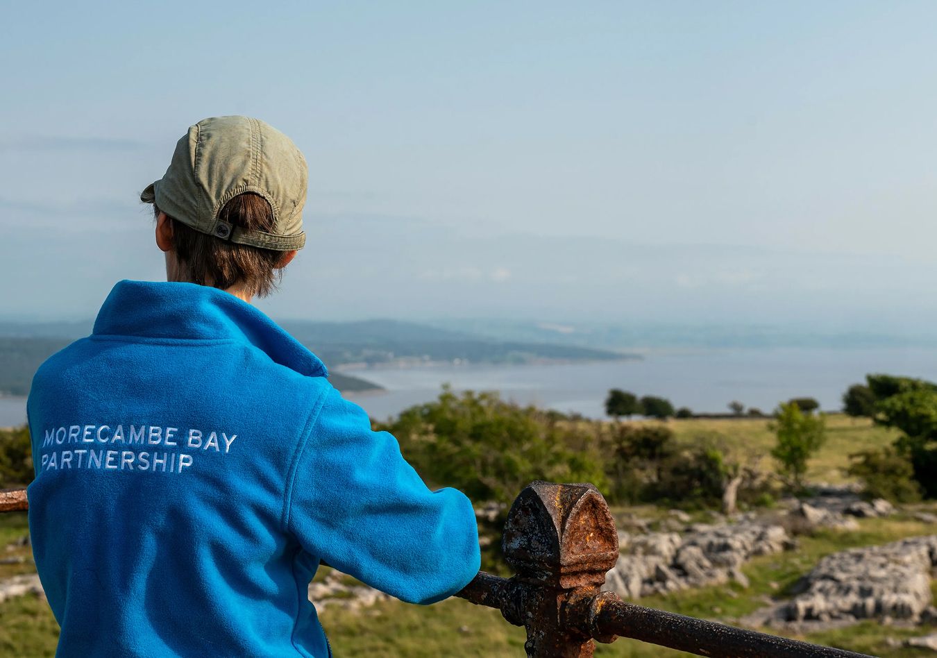 A man wearing Morecambe Bay Partnership branded apparel