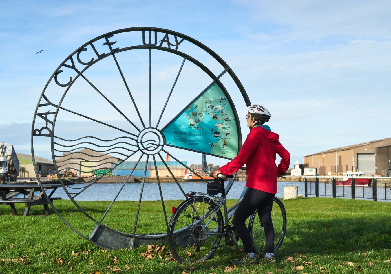 Cyclist Looking At The Bay Cycle Way Marker At Glasson Dock Wildey Media Scaled