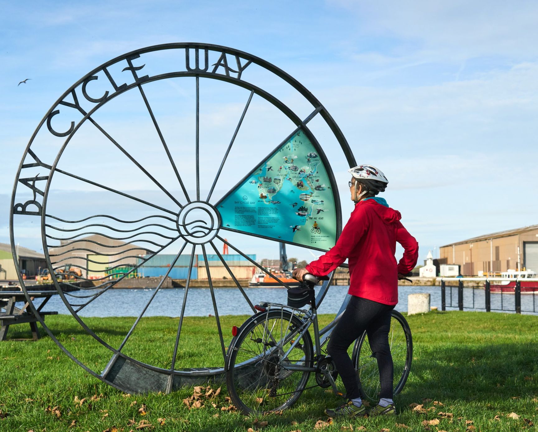 Cyclist Looking At The Bay Cycle Way Marker At Glasson Dock Wildey Media Scaled