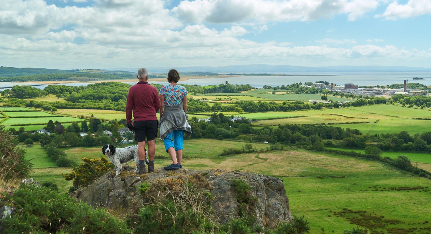 Two Walkers With Dog Looking Across Morecambe Bay From Path To The Hoad Wildey Media Scaled